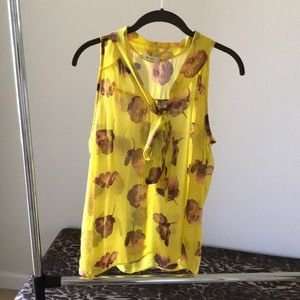 Sheer yellow blouse with flower print.